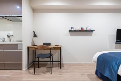 a bedroom with a desk and a bed at hotel aima in Tokyo