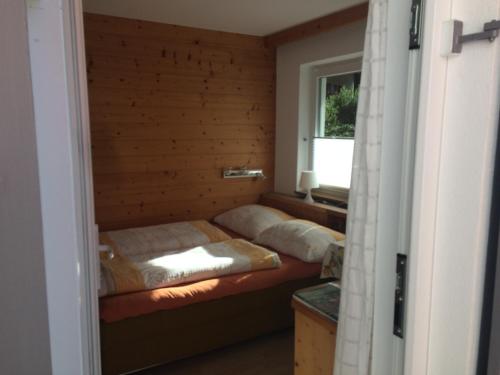 zwei Betten in einem Zimmer mit Fenster in der Unterkunft Waldhaus Lechner Steinerkogel in Mayrhofen