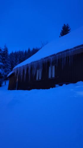 a house with snow on the side of it at Historisches Aschberg Haisl Klingenthal, Terrasse, großer Garten 6 plus 2 Personen in Klingenthal