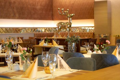 a dining room with a table and a deer statue at Falk Seehotel Plau am See in Plau am See