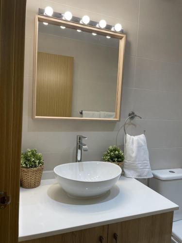 a bathroom with a white sink and a mirror at casa espiga in Benalmádena
