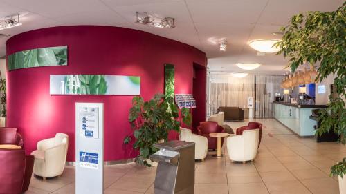 a living room filled with furniture and plants at Holiday Inn Express Marseille Saint Charles, an IHG Hotel in Marseille