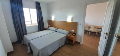 a hotel room with a bed and a desk at Primavera Loix in Benidorm