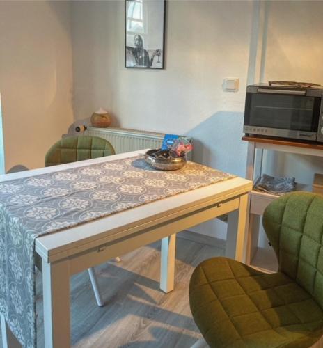 a table in a room with two chairs and a microwave at Ferienwohnung schöner Rheingau in Bad Schwalbach