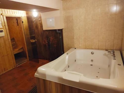 a large white bath tub in a bathroom at Troyan Plaza Hotel in Troyan