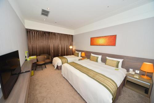 Uma cama ou camas num quarto em Grace Hotel