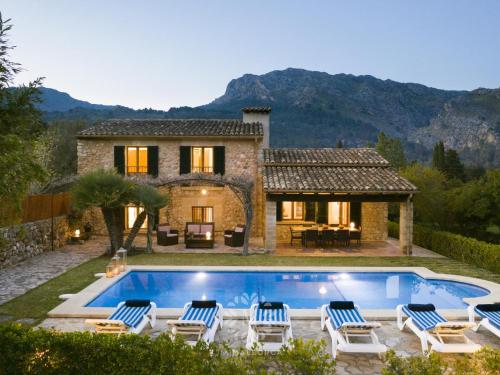 een villa met een zwembad voor een huis bij VILLA CAN PERIC WITH POOL Quiet and spacious in Pollença