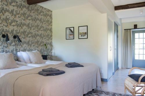 two beds in a hotel room with towels on them at Gumbalde Resort in Stånga