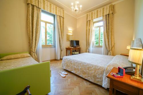 Ένα ή περισσότερα κρεβάτια σε δωμάτιο στο HG Hotel Cappelli