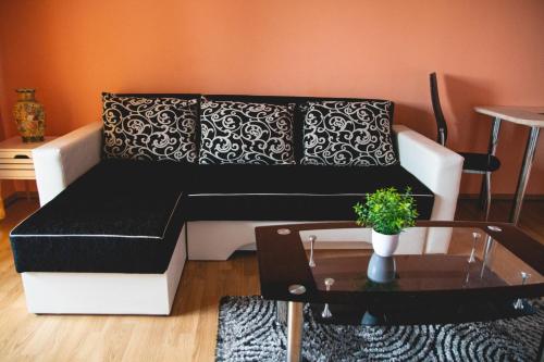 a black and white couch in a living room with a table at Relaxing residence in Sibiu