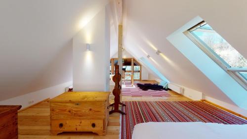 a attic room with a bed and a staircase at Charmante Gästewohnung in altem Bauernhaus in alpiner Alleinlage in Stanz Im Murztal