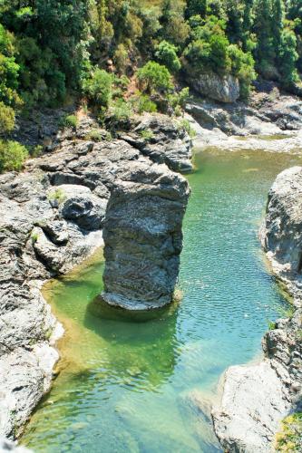 a river with a rock formation in the water at Cá de l’incantu in Molini di Triora