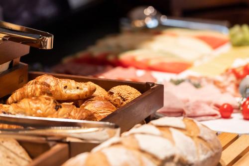 a bunch of different types of bread and pastries at HARBR Hotel Ludwigsburg, a member of Radisson Individuals in Ludwigsburg