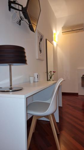 a white desk with a chair and a lamp at Villa Vittoria in Mesagne