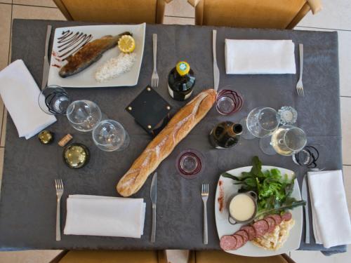 a table with two plates of food on it at Le Champ des Lys in Amancey