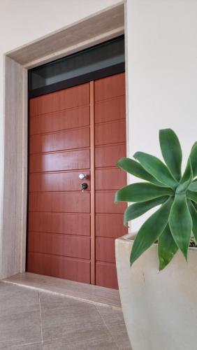 a red door with a plant in front of it at Villa Vittoria in Mesagne