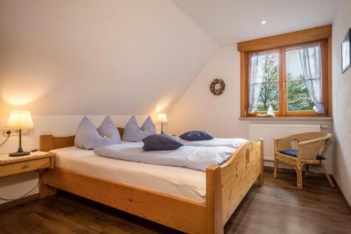 a bedroom with a bed with blue pillows on it at Ferienwohnung Henne in Weißensberg