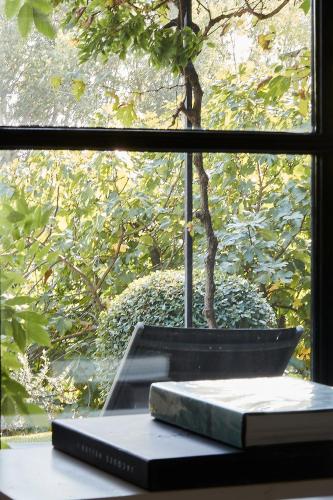 two books sitting on a table in front of a window at Mas des Songes in Monteux