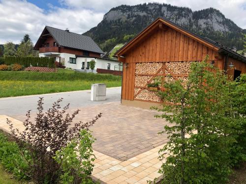 a building with a brick patio in front of a house at Haus Edelgrün in Tauplitz
