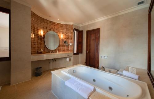 a large bathroom with a tub and a mirror at Sunrise Nha Trang Beach Hotel & Spa in Nha Trang