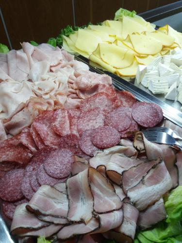 a display of meats and cheeses and other foods at Parkhotel Harrachov in Harrachov