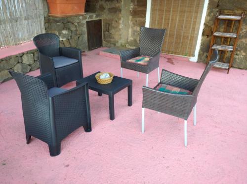 a group of chairs and tables on a patio at Dammuso à garca 'i Scauri in Pantelleria