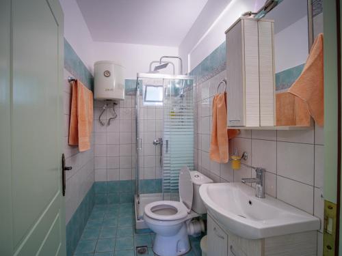 a bathroom with a toilet and a sink at Σπιτι στην εξοχη - Country House Milina in Milina