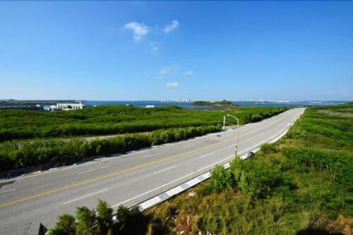an empty highway in the middle of a field at 嵵裡仙人掌海景民宿Ocean view room in Magong