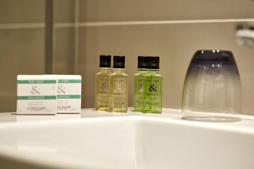 three bottles of essential oils sitting on a shelf at Auteuil Tour Eiffel in Paris