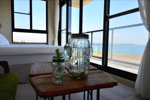 a table with two glass jars on top of it at 嵵裡仙人掌海景民宿Ocean view room in Magong