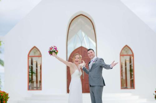 a bride and groom standing in front of a church at Shangri-La Yanuca Island, Fiji in Voua
