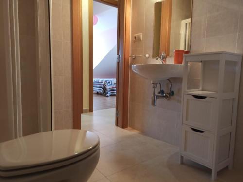 a bathroom with a toilet and a sink at CASA CHALET ATALAYA a pie de playa en Laxe in Laxe