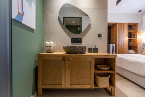 a bathroom with a sink and a mirror at Moncasa Your Ionian home in Kouvaláta