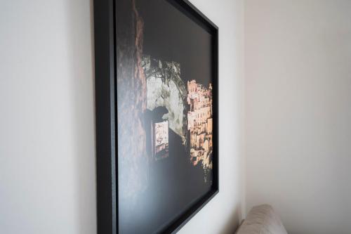 a television hanging on a wall in a room at Antica Pepice in Matera