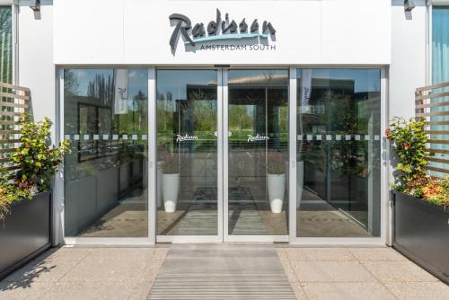 an entrance to a building with glass doors at Radisson Hotel & Suites Amsterdam South in Amstelveen