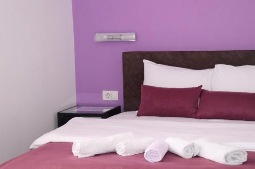 a bedroom with a bed with two towels on it at Restoran & Motel Manjež in Bijelo Polje