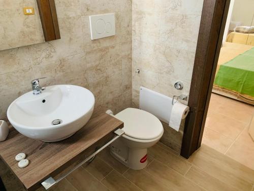a bathroom with a sink and a toilet at Fly House in Guagnano
