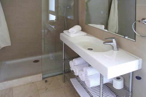 a bathroom with a sink and a shower at Flat in La Escala with a terrace in L'Escala
