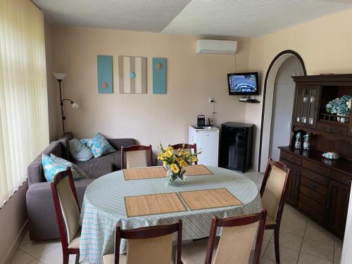 a living room with a table and a couch at Ágnes Nyaralóház in Balatonmáriafürdő