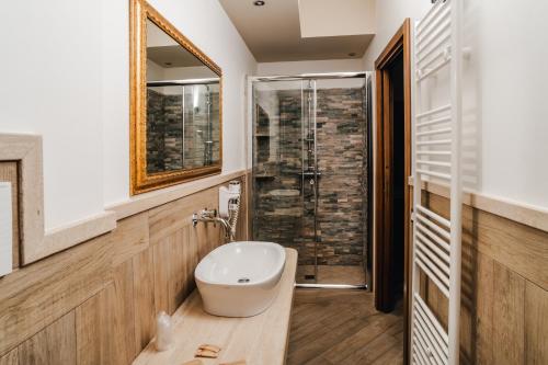 a bathroom with a sink and a glass shower at Holiday Gli Archi in Fasano