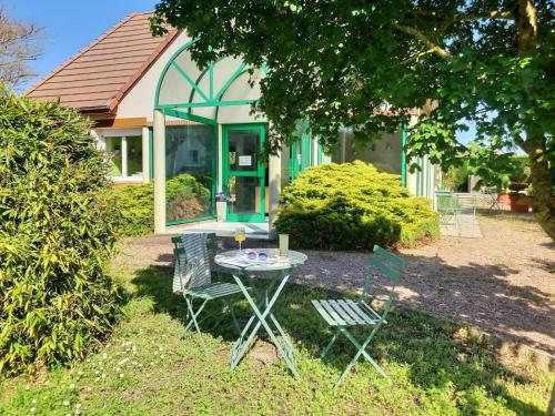 a table and chairs in front of a house at Logis Hôtel du Château in Tour-en-Sologne