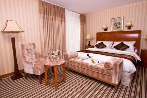 a hotel room with a bed and a chair at Hotel Park Exclusive in Otočac