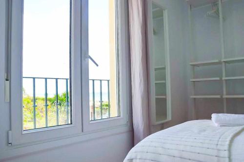 a bedroom with a bed and a window with a view at Brisa Chilches nº 6 in Vélez-Málaga
