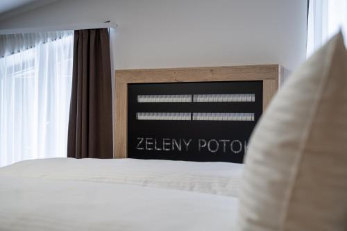 a bedroom with a sign that reads zenifyrior at Hotel Zelený potok in Pec pod Sněžkou