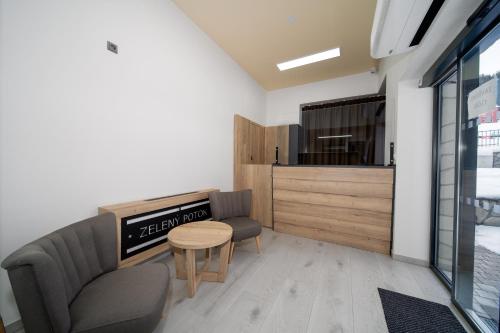 a waiting room with a couch and a table at Hotel Zelený potok in Pec pod Sněžkou