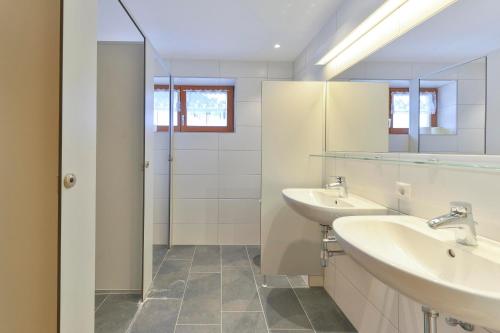 a bathroom with two sinks and a shower at Chalet Klösterle in Wilden