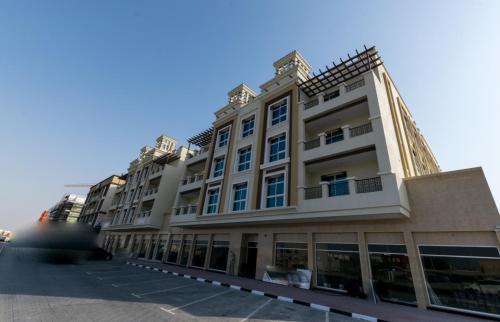 a large white building with a lot of windows at Budget Rental Apartments in Dubai in Dubai