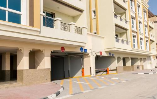 an empty parking lot in front of a building at Budget Rental Apartments in Dubai in Dubai