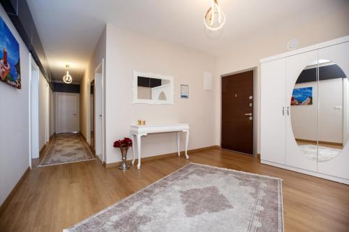 a living room with a table and a hallway at Armoni Deluxe Suites Trabzon in Trabzon