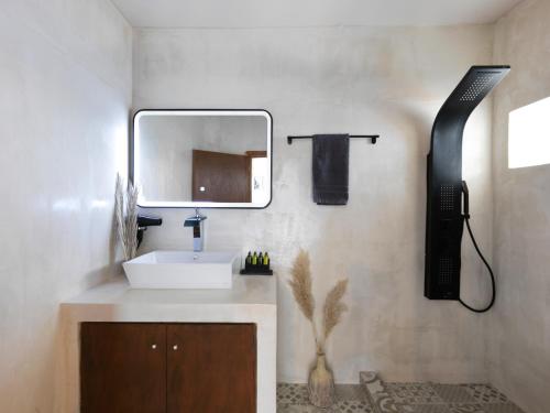a bathroom with a sink and a mirror at Secret Gem Suites in Oia